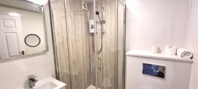 a bathroom with a shower and a sink at 12 Wheal Ramoth in Perranporth