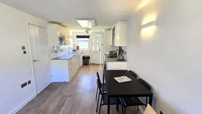 a kitchen and dining room with a table and chairs at 12 Wheal Ramoth in Perranporth