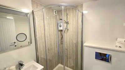 a shower with a glass door in a bathroom at 12 Wheal Ramoth in Perranporth