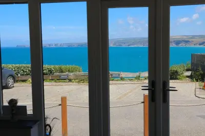 a view of the ocean from a window at Cockleshell, Port Isaac Bay Holidays in Port Isaac