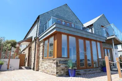 a house with a glass roof on top of it at Cockleshell, Port Isaac Bay Holidays in Port Isaac
