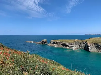 a large body of water with rocks in it at The Rockies, Port Isaac Bay Holidays in Port Isaac
