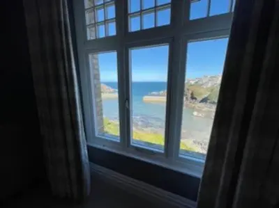 a window with a view of the ocean from a room at Folly 1, Port Isaac Bay Holidays in Port Isaac