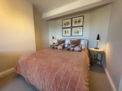 a bedroom with a large bed in a room at Folly 1, Port Isaac Bay Holidays in Port Isaac