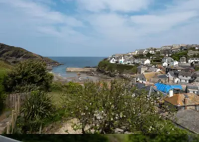 a view of a town with a body of water at Kicker Cottage, Port Isaac Bay Holidays in Port Isaac