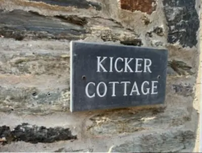 a sign on a brick wall with the words kitchen coffee at Kicker Cottage, Port Isaac Bay Holidays in Port Isaac
