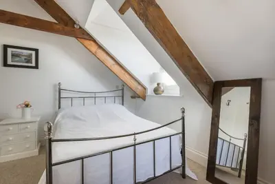 a bedroom with a bed in a attic at Upper Deck, Port Isaac Bay Holidays in Port Isaac