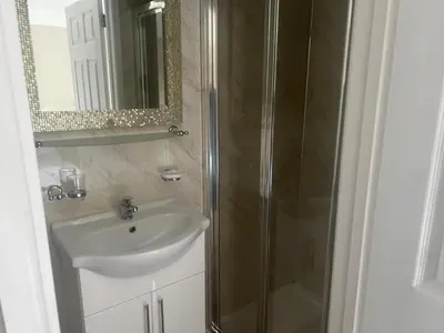 a bathroom with a sink and a shower at Coach and Horses INN in Penzance