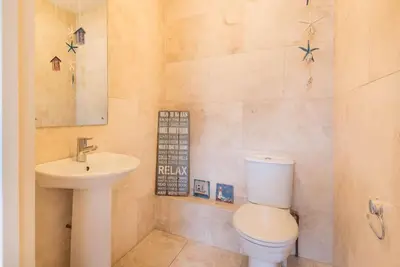 a bathroom with a toilet and a sink at Sea Gem, Port Isaac Bay Holidays in Port Isaac