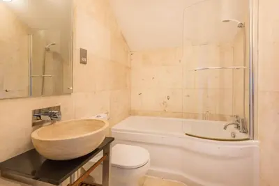 a bathroom with a tub and a toilet and a sink at Sea Gem, Port Isaac Bay Holidays in Port Isaac