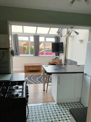 a kitchen with a stove and a counter top at Comfy and welcoming 2 bedroom Annex. in Padstow