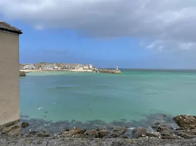 a large body of water with a town in the background at The Little Snug in St Ives in St Ives