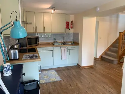 a small kitchen with a sink and a microwave at 1 bed-Pet Friendly-Parking-Patio-close to coasts in North Hill