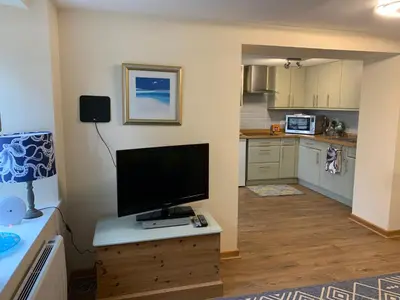 a kitchen with a flat screen tv on a wooden table at 1 bed-Pet Friendly-Parking-Patio-close to coasts in North Hill