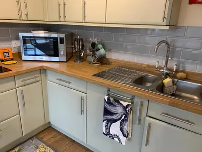a kitchen counter with a sink and a microwave at 1 bed-Pet Friendly-Parking-Patio-close to coasts in North Hill