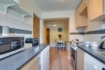 a kitchen with white appliances and a counter top at Ebrel, Port Isaac Bay Holidays in Port Isaac