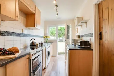 a kitchen with a sink and a dishwasher at Ebrel, Port Isaac Bay Holidays in Port Isaac