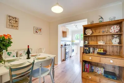 a kitchen and dining room with a table and chairs at Ebrel, Port Isaac Bay Holidays in Port Isaac