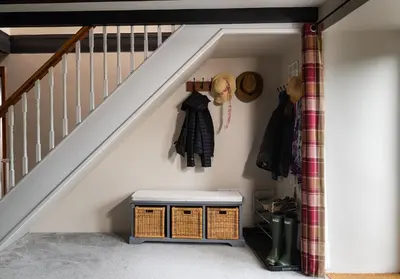 a room with a staircase with a stool under it at The Old Farmhouse in Michaelstow