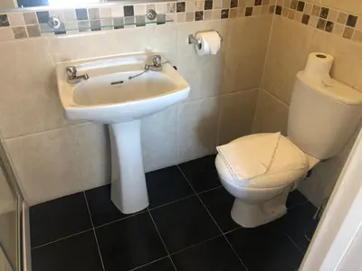 a bathroom with a sink and a toilet at Southcote Accommodation in Tintagel