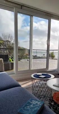 a living room with a view of a large window at May View - Luxury Sea View Apartment - Millendreath, Looe in Looe
