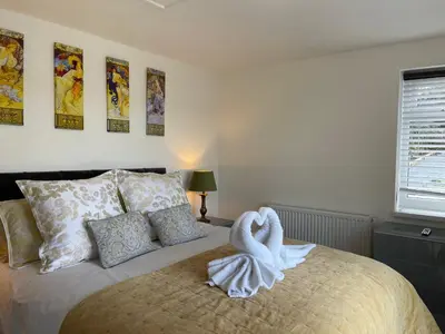 a bedroom with a bed with a swan on it at The View in Bodmin