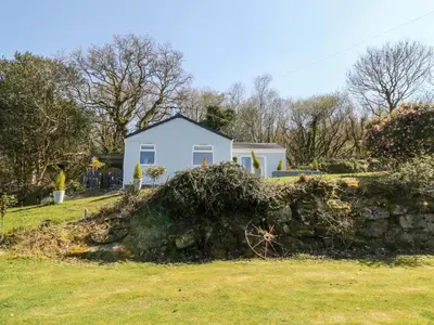 a white house behind a stone wall at The View in Bodmin