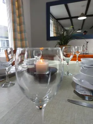a table with wine glasses and a candle on it at 3.9. Tudor Court in Hayle