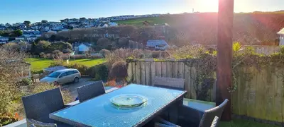 a table and chairs on a balcony with a view at Parkside in Perranporth