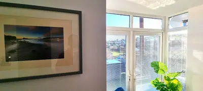 a living room with a large window and a picture at Parkside in Perranporth