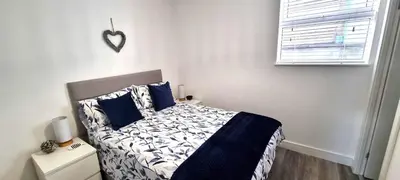 a bedroom with a bed and a heart on the wall at Parkside in Perranporth