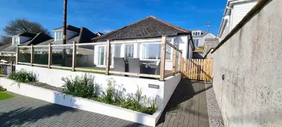 a house with a porch with plants on it at Parkside in Perranporth