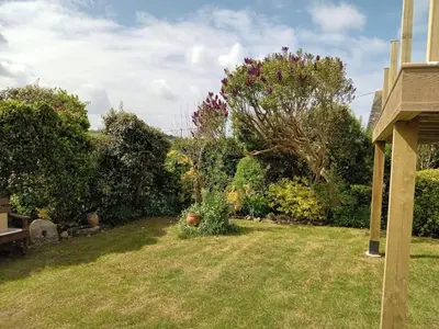 a yard with some bushes and trees at Curlews Cottage - House with 3 bedrooms and garden - walking distance to the beach in Perranporth