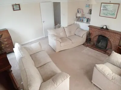 a living room with two couches and a fireplace at Curlews Cottage - House with 3 bedrooms and garden - walking distance to the beach in Perranporth