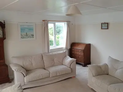 a living room with two couches and a window at Curlews Cottage - House with 3 bedrooms and garden - walking distance to the beach in Perranporth