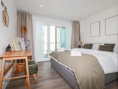 a bedroom with a bed and a desk and a window at 33 Cliff Edge in Newquay