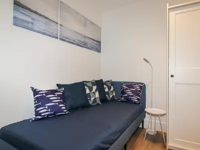 a blue couch with pillows in a living room at 33 Cliff Edge in Newquay