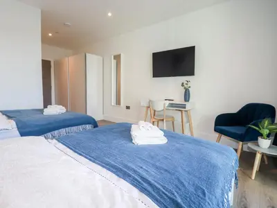a hotel room with two beds and a tv at 33 Cliff Edge in Newquay