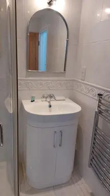 a white bathroom with a sink and a mirror at Tregarthen Cottage - tranquil self-contained room near Looe offering easy parking right outside with EV point in Looe