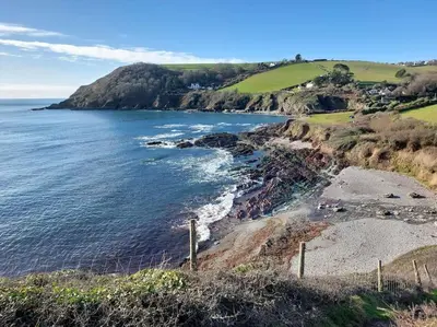a view of the ocean from a bluff at Tregarthen Cottage - tranquil self-contained room near Looe offering easy parking right outside with EV point in Looe