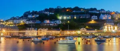 a group of boats in a harbor at night at Tregarthen Cottage - tranquil self-contained room near Looe offering easy parking right outside with EV point in Looe