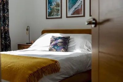 a bedroom with a bed with a pillow on it at Huckleberry - Premium, Hot Tub, x2 Parking, Farm Shop Next door, Private Cornish Lane in Newquay