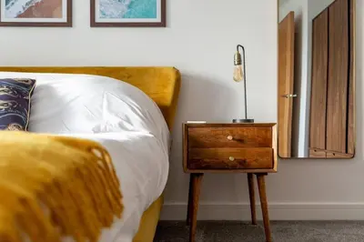 a bedroom with a bed and a nightstand next to a bed sidx sidx sidx at Huckleberry - Premium, Hot Tub, x2 Parking, Farm Shop Next door, Private Cornish Lane in Newquay