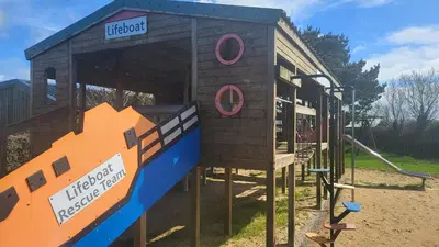 a small wooden play house on a playground at Honeycomb Lodge - Holiday Home 5 min from Padstow in Padstow