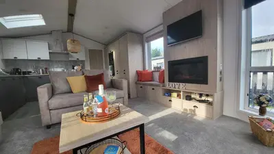 a living room with a couch and a tv at Honeycomb Lodge - Holiday Home 5 min from Padstow in Padstow