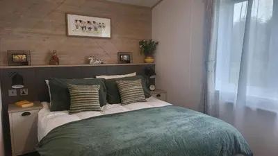 a bedroom with a bed with pillows on it at Honeycomb Lodge - Holiday Home 5 min from Padstow in Padstow