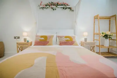 a bedroom with a large bed with two pillows at 7 Cliff Edge in Newquay