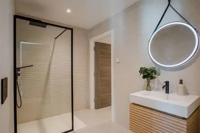 a bathroom with a shower and a sink and a mirror at 7 Cliff Edge in Newquay