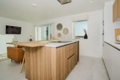 a kitchen with a wooden island with a sink at 7 Cliff Edge in Newquay