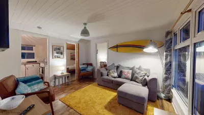 a living room with a couch and a table at A18 Bojago, Riviere Towans in Hayle